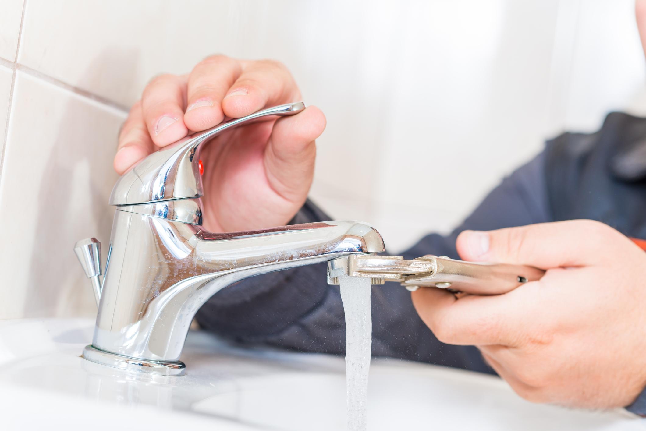 Plumber testing a new bathroom faucet