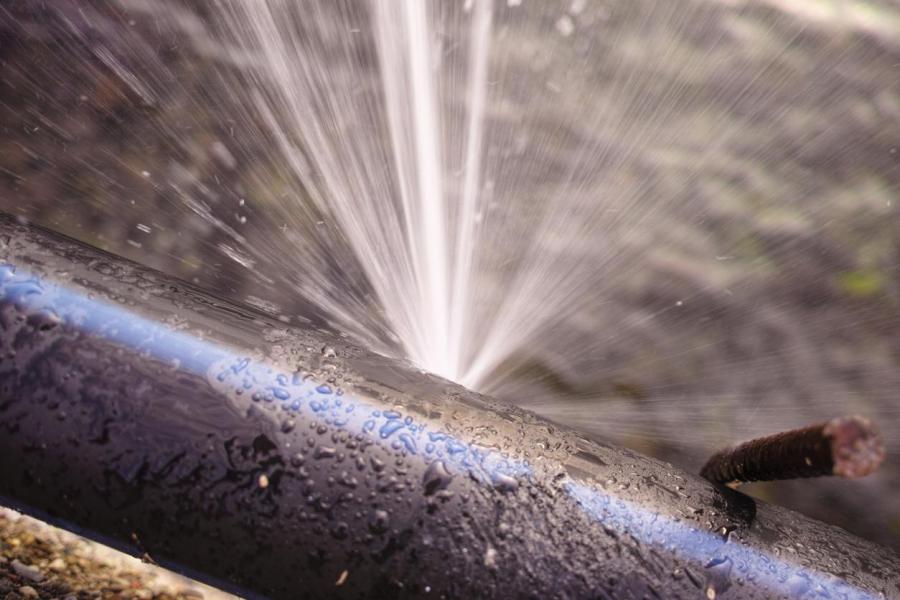 Detail of a broken pipe spraying water