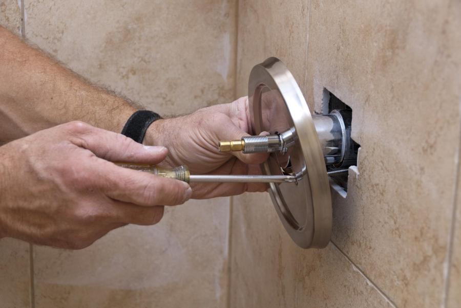 Plumber installing a new shower and tub fixture