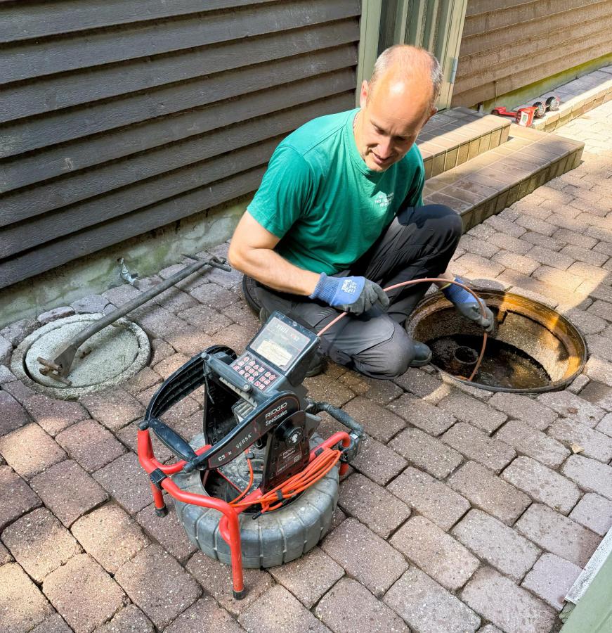 Plumber inspecting a residential sewer system