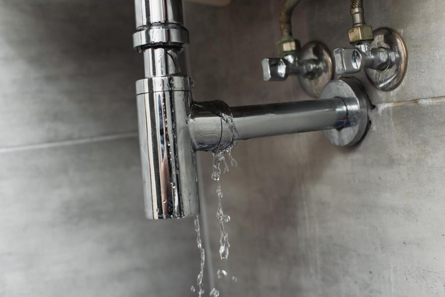Water leaking from a bathroom sink p-trap